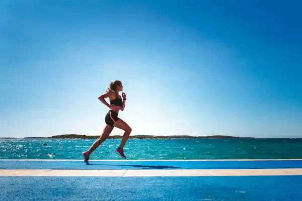 Woman running showing strong leg muscle Belper
